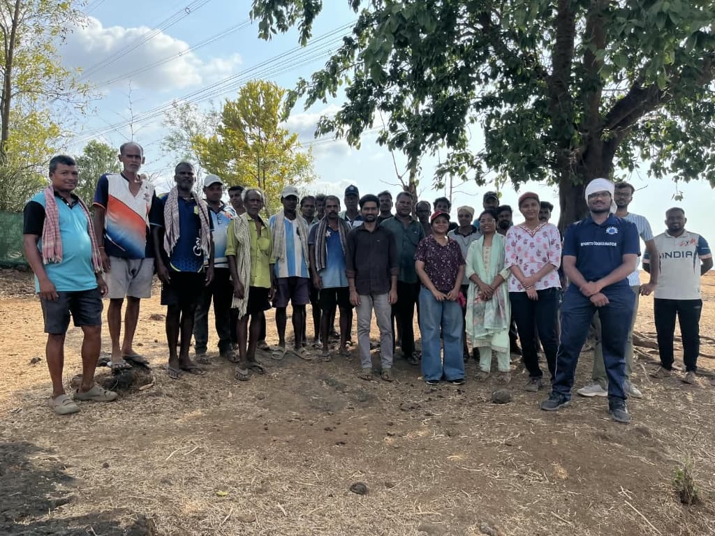 Students and village elders in dialogue under the village tree in Palghar